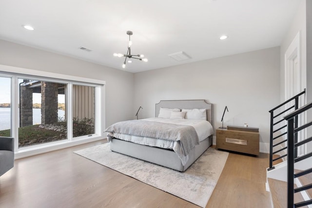 5893 Cairo Bend Rd, Lebanon, TN 37087 - bedroom featuring wood finished floors, a chandelier, recessed lighting, a water view, and baseboards