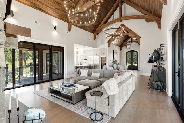 living room featuring wood ceiling, high vaulted ceiling, beamed ceiling, and light hardwood / wood-style flooring