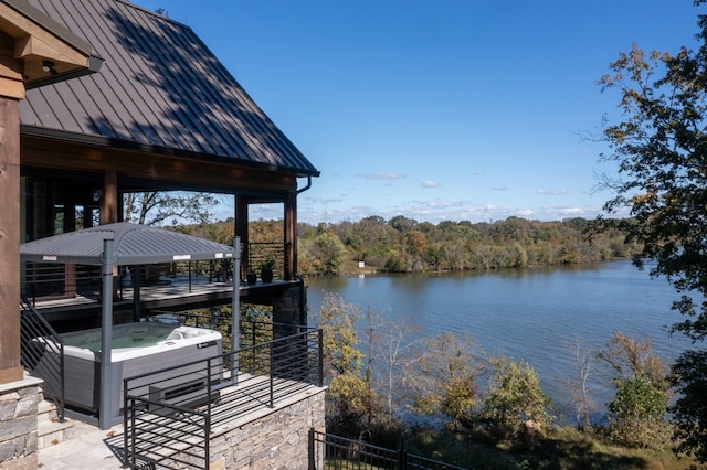 dock area with a hot tub, a gazebo, and a water view