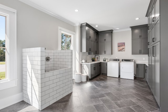 interior space with vanity, washing machine and clothes dryer, and ornamental molding