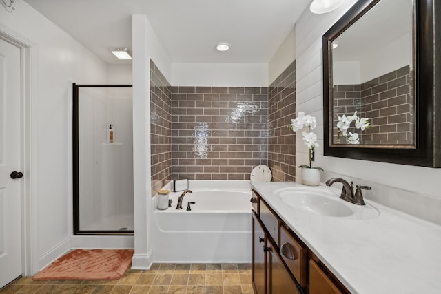 bathroom featuring vanity and shower with separate bathtub