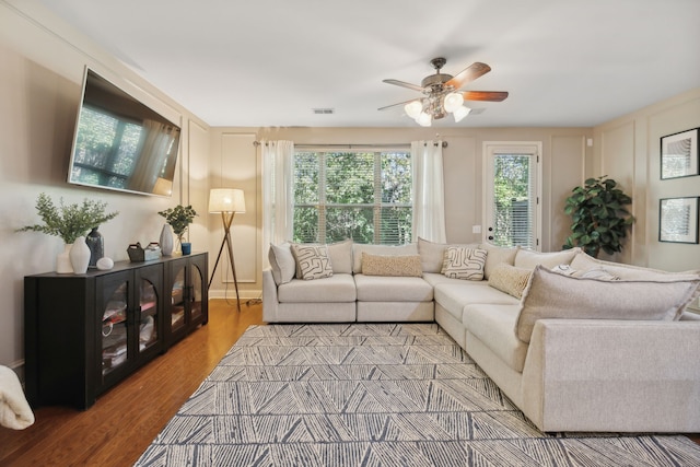 living room with ceiling fan and hardwood / wood-style floors