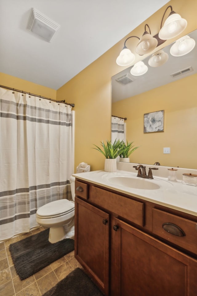 bathroom with vanity, walk in shower, and toilet