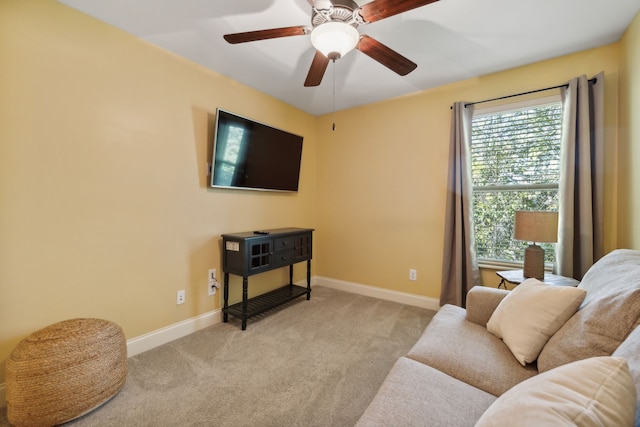 living room featuring light colored carpet and ceiling fan