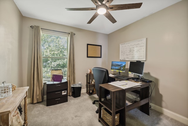 home office featuring light carpet and ceiling fan