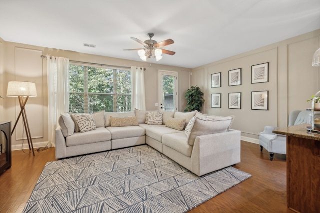 living room featuring hardwood / wood-style flooring and ceiling fan