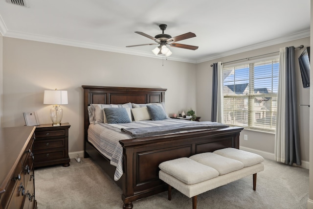 bedroom featuring ceiling fan, ornamental molding, and light colored carpet