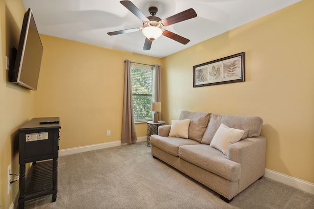 carpeted living room with ceiling fan