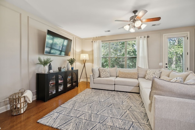 living room featuring ceiling fan and hardwood / wood-style floors