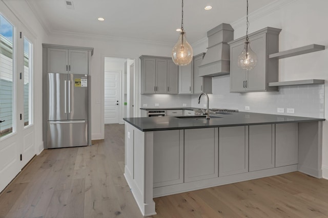 kitchen with a sink, freestanding refrigerator, and gray cabinetry