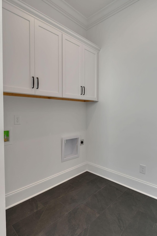 laundry room with cabinet space, baseboards, crown molding, washer hookup, and electric dryer hookup