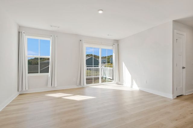 unfurnished room with light wood-type flooring