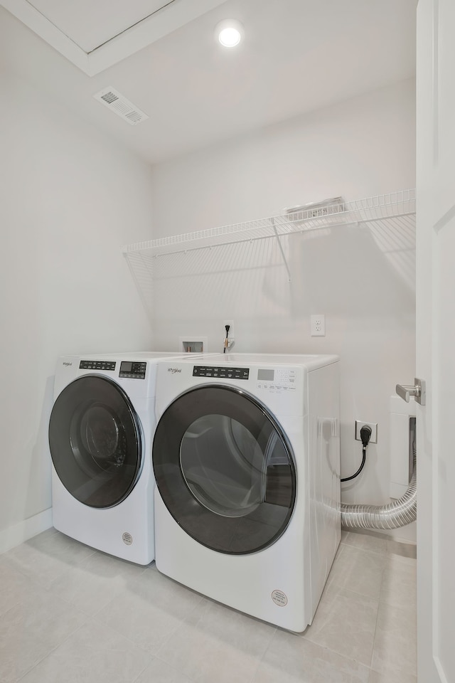 washroom featuring separate washer and dryer and light tile patterned floors