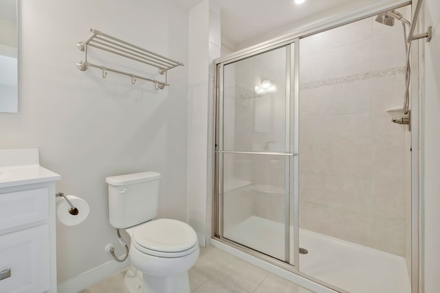 bathroom featuring vanity, toilet, walk in shower, and tile patterned flooring