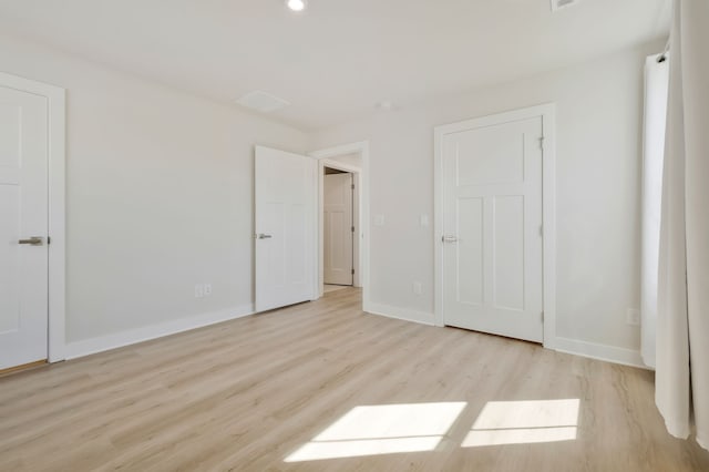 unfurnished bedroom with light hardwood / wood-style floors