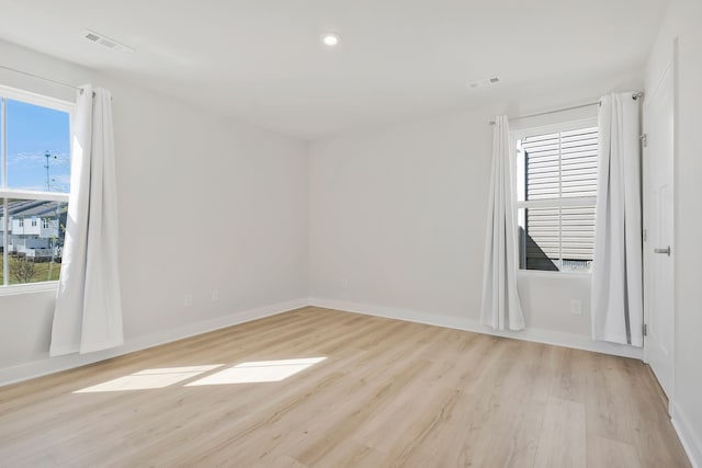 spare room with light hardwood / wood-style floors