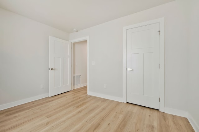 unfurnished bedroom with light wood-type flooring