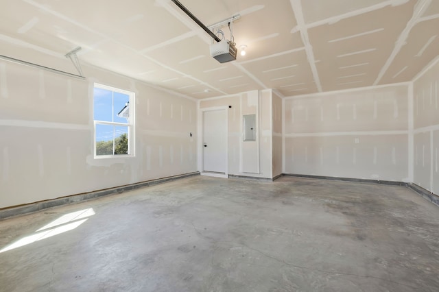 garage with a garage door opener and electric panel