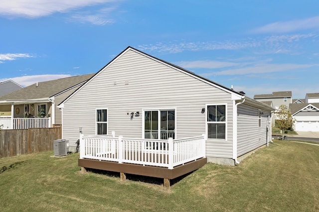 rear view of property with a wooden deck, central AC, a yard, and a garage