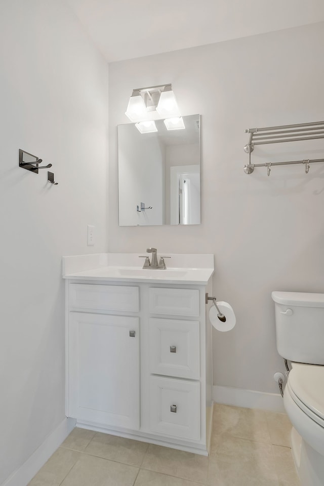 bathroom featuring vanity, toilet, and tile patterned floors