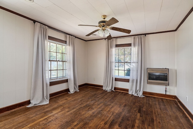 unfurnished room with ceiling fan, heating unit, a healthy amount of sunlight, and dark hardwood / wood-style flooring