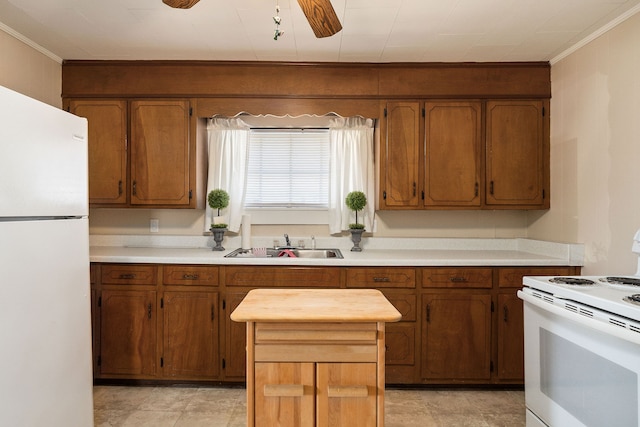 kitchen featuring ornamental molding, ceiling fan, sink, and white appliances