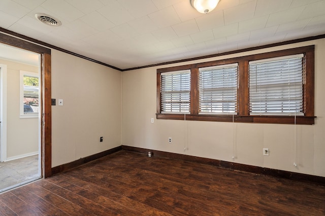 unfurnished room with crown molding and dark hardwood / wood-style floors