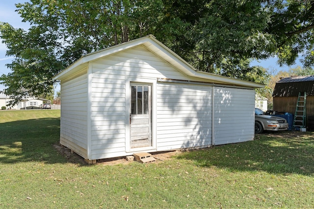 view of outbuilding with a lawn