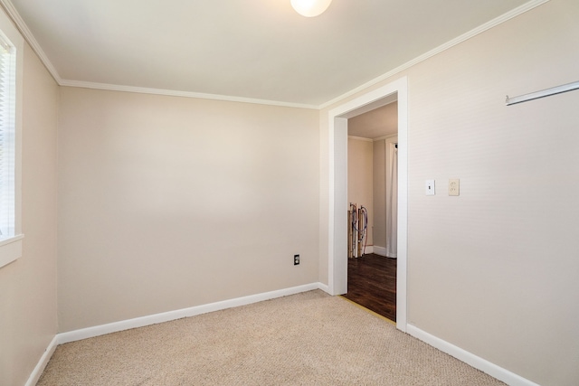 carpeted spare room with crown molding