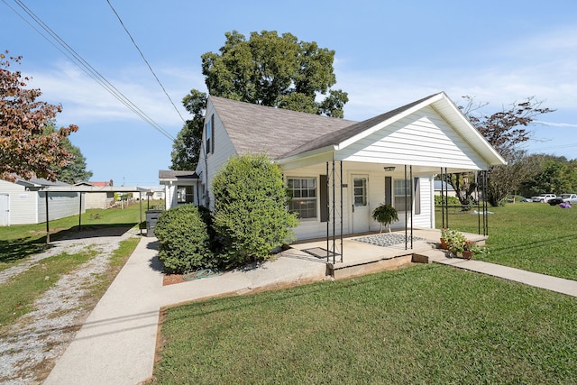 bungalow-style house featuring covered porch and a front lawn