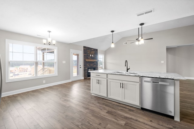 kitchen featuring a center island with sink, dishwasher, light stone countertops, white cabinets, and sink