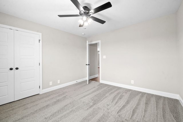 unfurnished bedroom with ceiling fan, a closet, and carpet flooring