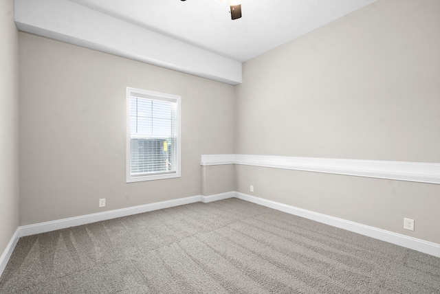 empty room with ceiling fan and carpet flooring