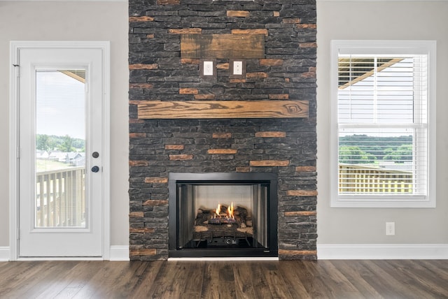 room details featuring hardwood / wood-style floors and a stone fireplace