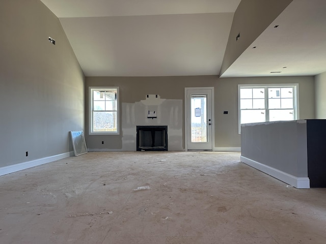 unfurnished living room featuring vaulted ceiling