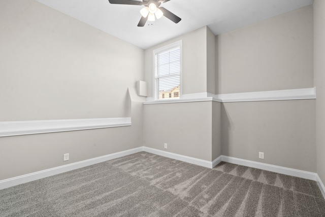 carpeted spare room featuring ceiling fan and vaulted ceiling