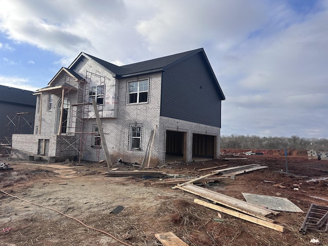 rear view of house with a garage