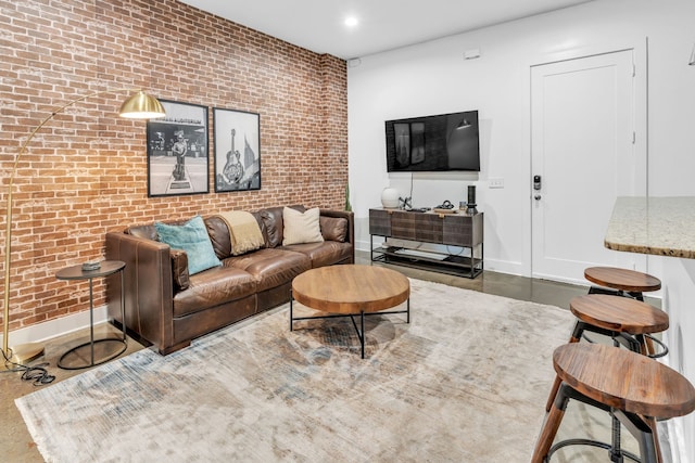 living room featuring brick wall