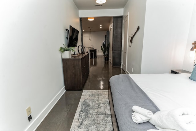 210 30th Ave N Unit 209, Nashville, TN 37203 - bedroom featuring finished concrete flooring, baseboards, and visible vents