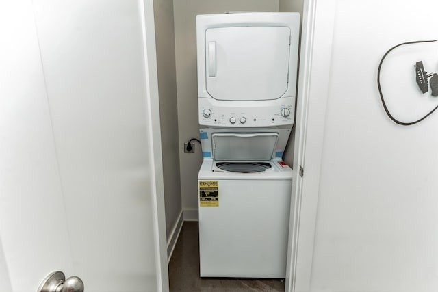 210 30th Ave N Unit 209, Nashville, TN 37203 - washroom with laundry area, stacked washing maching and dryer, and baseboards