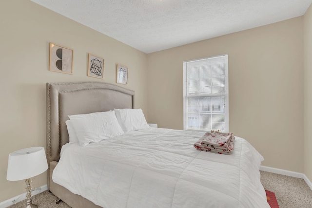 carpeted bedroom featuring a textured ceiling