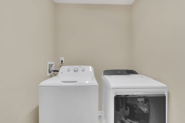 clothes washing area with washer and dryer