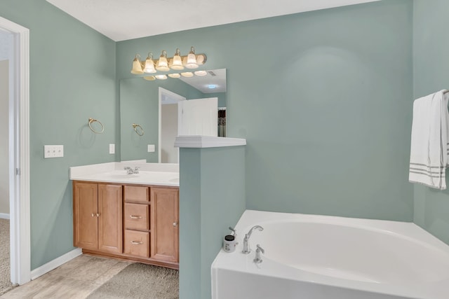 bathroom with vanity and a washtub