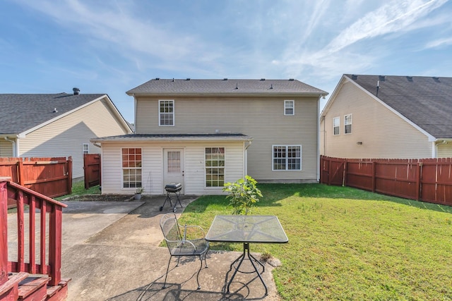 rear view of house with a patio area and a yard