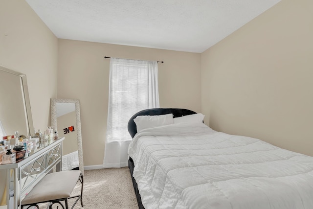 carpeted bedroom featuring a textured ceiling