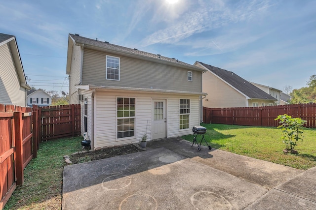 rear view of house featuring a patio and a lawn