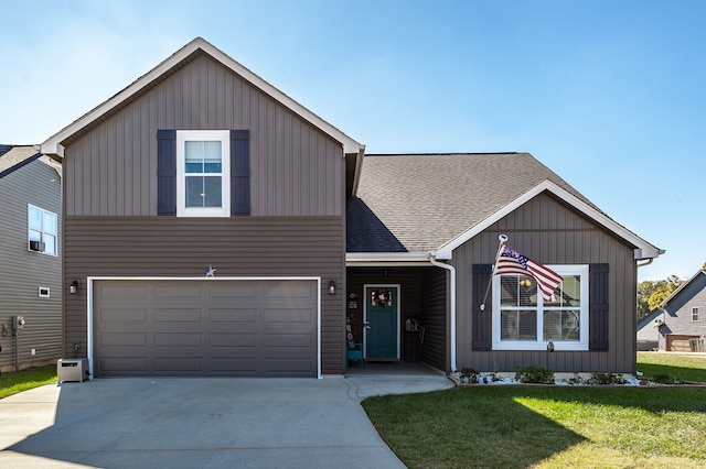 view of front of home featuring a front yard and a garage