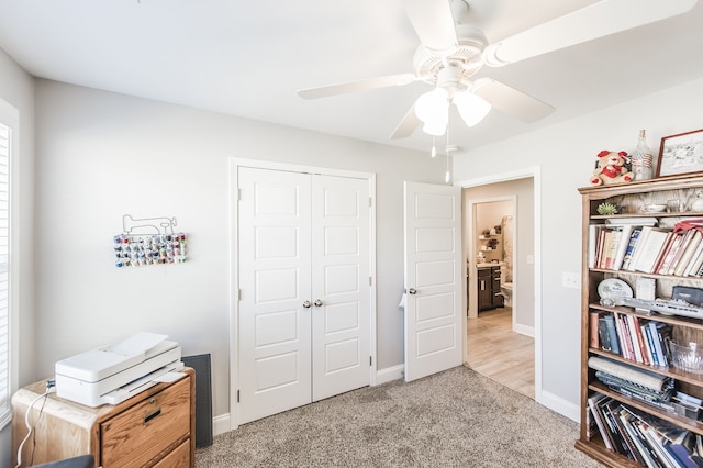 bedroom featuring light carpet, a closet, and ceiling fan