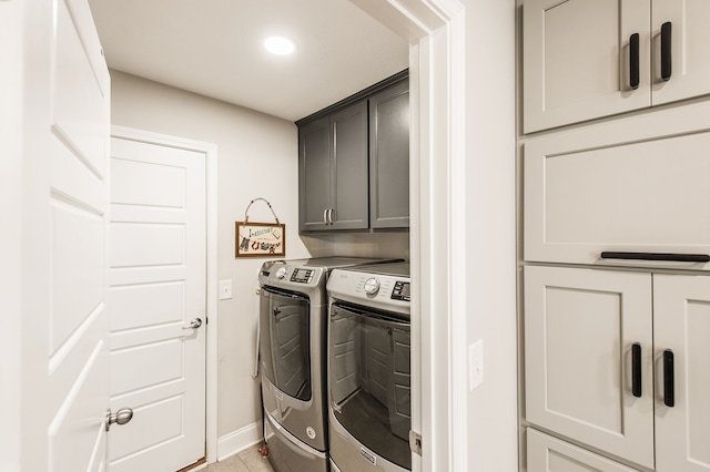 washroom with separate washer and dryer and cabinets