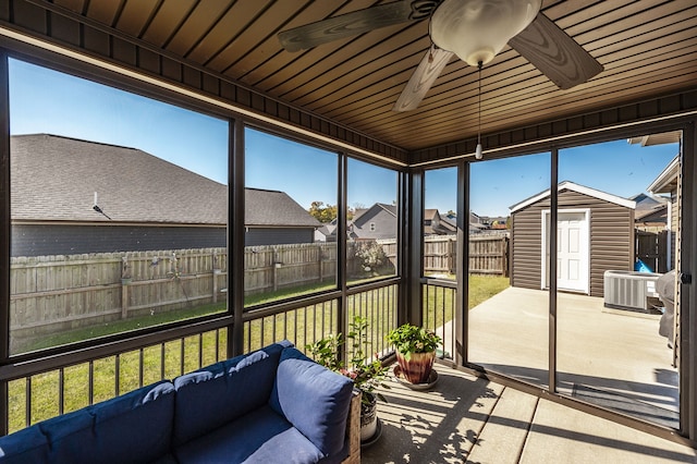 sunroom / solarium with wood ceiling and ceiling fan